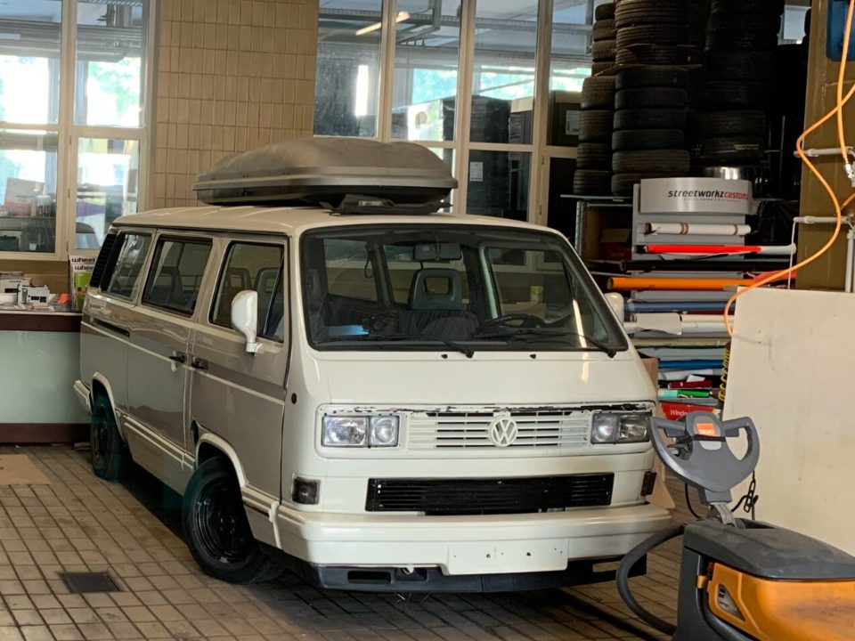 White VW T3 van inside our tiled workshop hall in St. Gallen